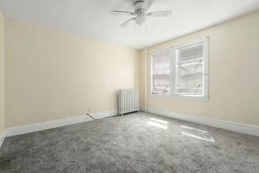 145-169 N Washington St, Boston, MA 02114 - carpeted empty room featuring radiator heating unit, a ceiling fan, and baseboards