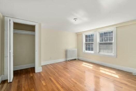 145-169 N Washington St, Boston, MA 02114 - unfurnished bedroom with radiator heating unit, wood finished floors, and baseboards