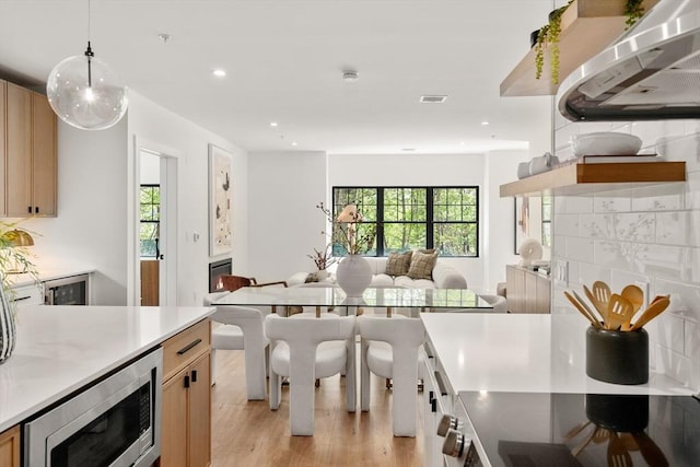 20 Audubon Way Unit 208, Canton, MA 02021 - kitchen featuring stainless steel microwave, open floor plan, light wood-type flooring, plenty of natural light, and recessed lighting