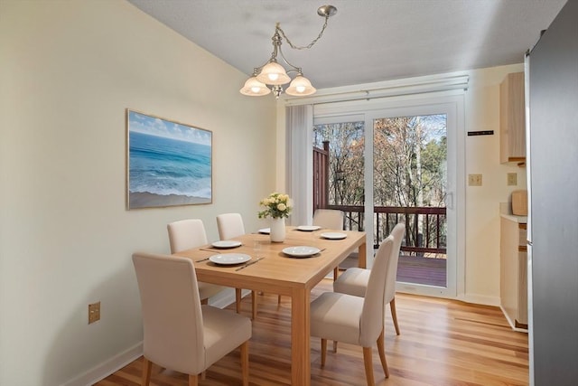 dining area featuring a chandelier and light wood-type flooring