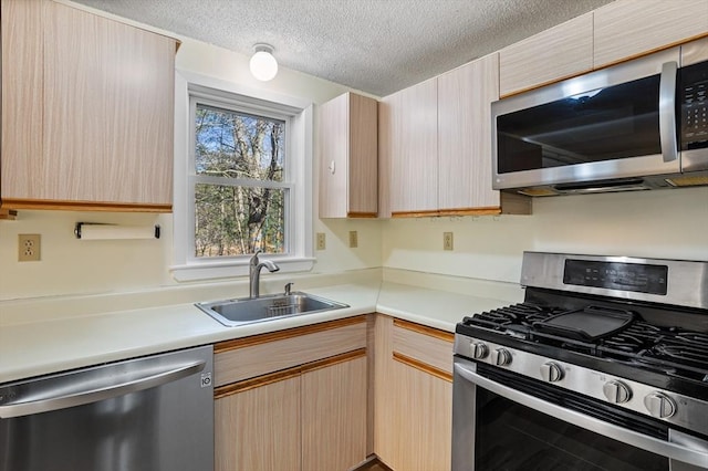 kitchen featuring sink, stainless steel appliances, and light brown cabinets