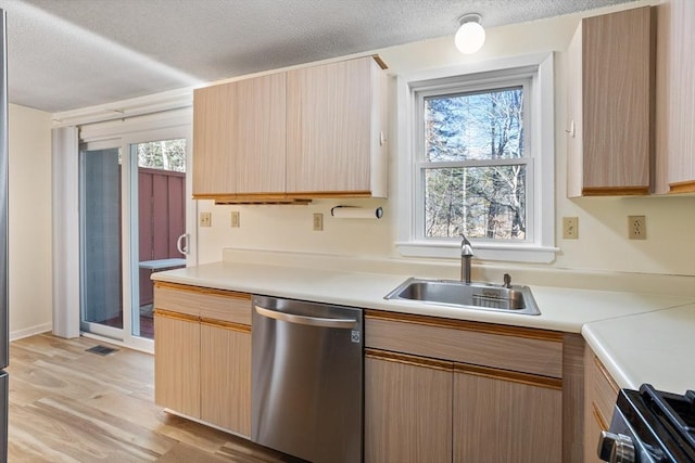 kitchen with a textured ceiling, dishwasher, stove, and sink