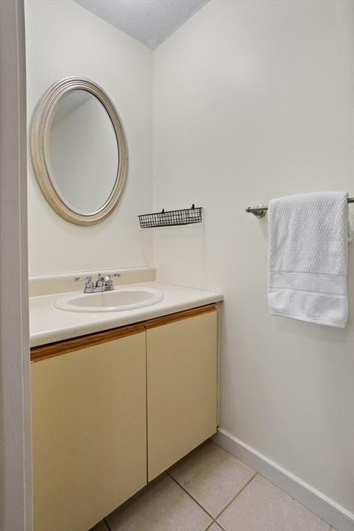 bathroom featuring tile patterned flooring and vanity