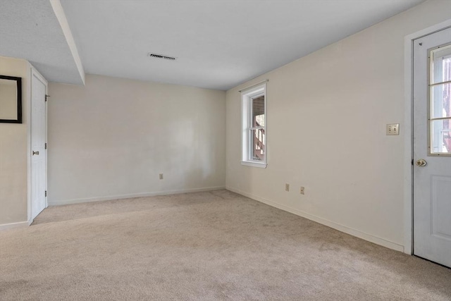 unfurnished room with light colored carpet