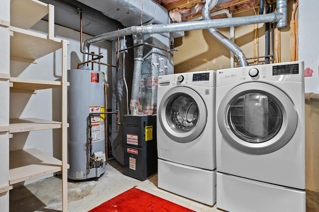 clothes washing area with water heater and washer and dryer