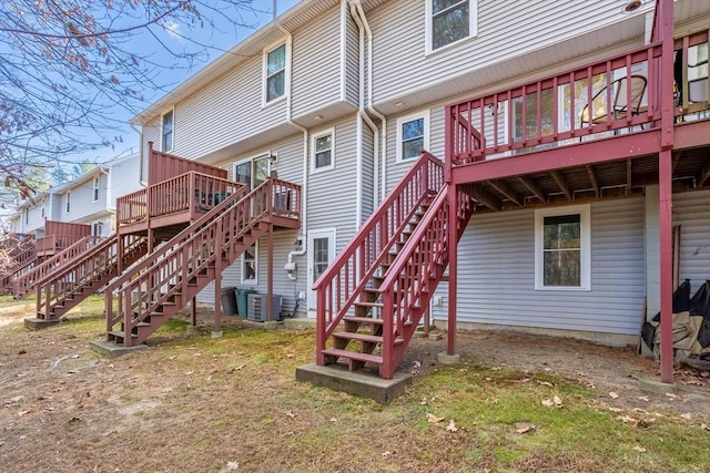 back of property featuring cooling unit and a deck