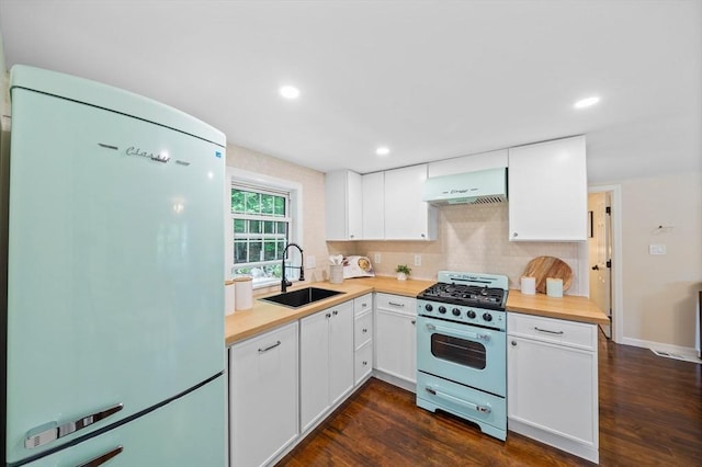 9 Josephine, Canton, MA 02021 - kitchen with freestanding refrigerator, stainless steel gas range oven, a sink, under cabinet range hood, and dark wood-type flooring