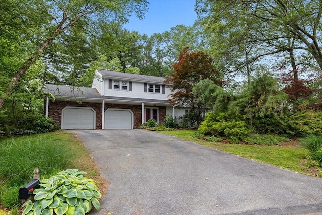 23 Eastview Ave, Billerica, MA 01821 - view of front of house with an attached garage, asphalt driveway, and brick siding