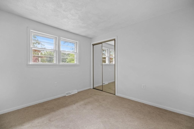23 Eastview Ave, Billerica, MA 01821 - unfurnished bedroom with carpet flooring, a textured ceiling, and a closet