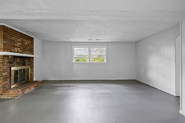 23 Eastview Ave, Billerica, MA 01821 - unfurnished living room featuring concrete flooring, a brick fireplace, and a textured ceiling