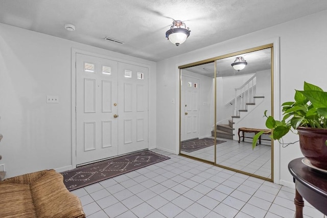 23 Eastview Ave, Billerica, MA 01821 - foyer with stairway and light tile patterned flooring