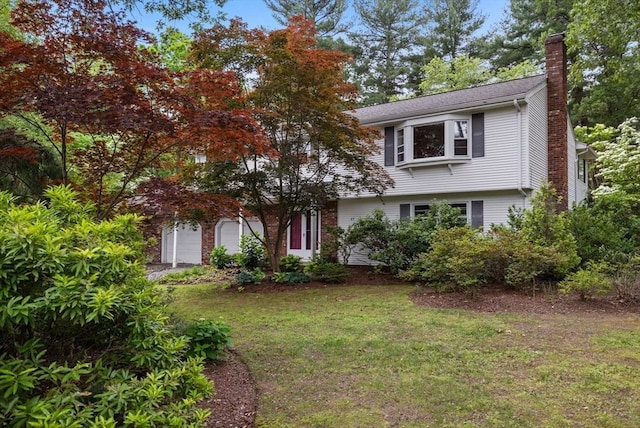 23 Eastview Ave, Billerica, MA 01821 - view of front of property featuring a chimney, a front lawn, and a garage