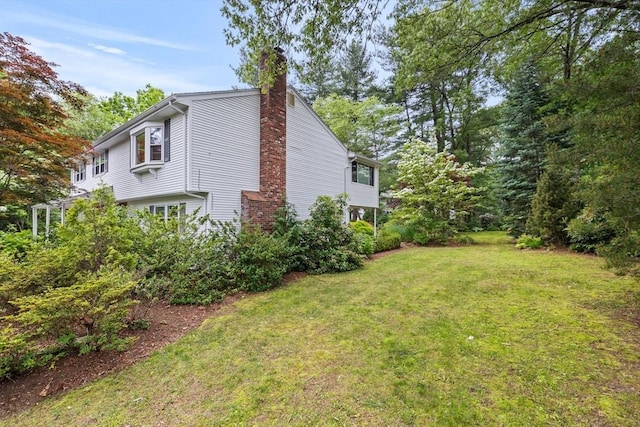 23 Eastview Ave, Billerica, MA 01821 - view of side of home featuring a yard and a chimney