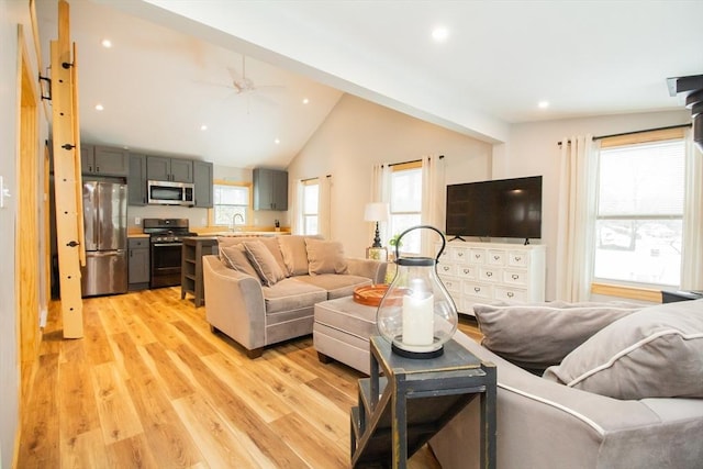 living area with lofted ceiling, recessed lighting, a ceiling fan, and light wood-style floors