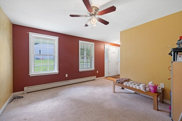 playroom with ceiling fan, carpet, and a baseboard heating unit