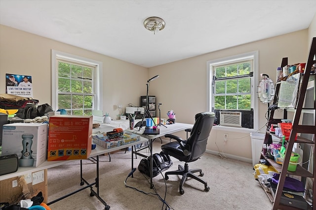 home office with cooling unit, light carpet, and a healthy amount of sunlight