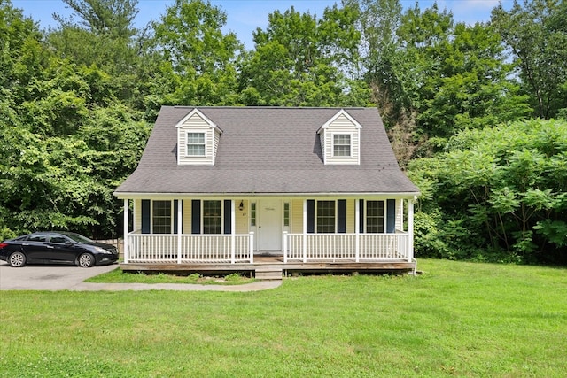 cape cod house with a porch and a front lawn