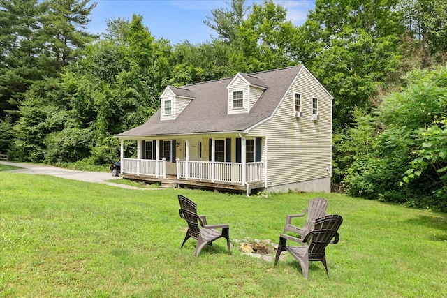 cape cod home featuring covered porch and a front yard