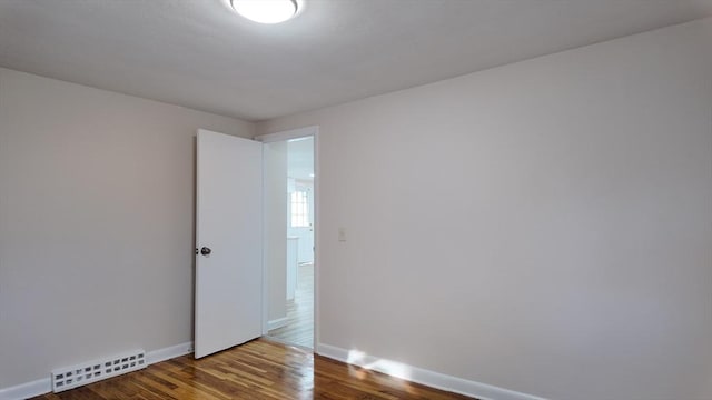 unfurnished room with hardwood / wood-style flooring