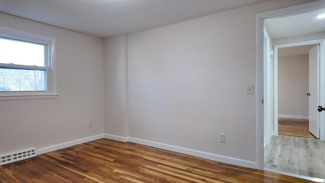 spare room with hardwood / wood-style flooring