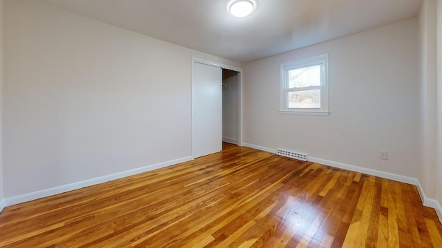 unfurnished bedroom featuring hardwood / wood-style flooring and a closet