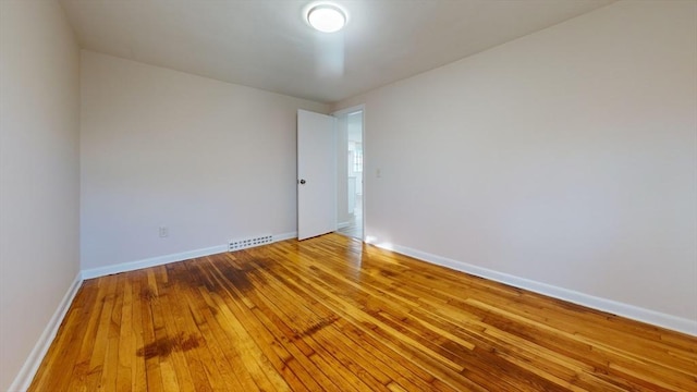 spare room featuring wood-type flooring