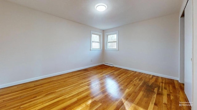 spare room featuring light hardwood / wood-style floors