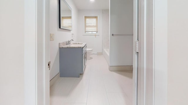 bathroom with tile patterned floors, vanity, and toilet