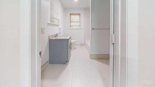 bathroom featuring tile patterned flooring, vanity, and toilet