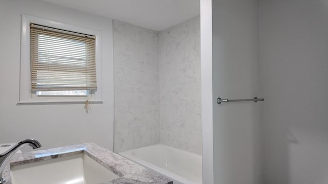 bathroom featuring vanity and washtub / shower combination