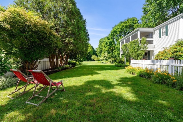 view of yard with a balcony