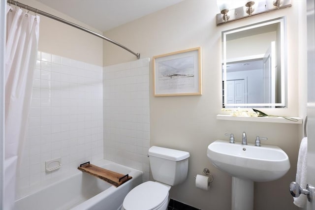 bathroom with shower / bath combo and toilet