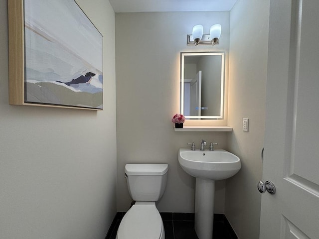 bathroom featuring tile patterned floors, sink, and toilet