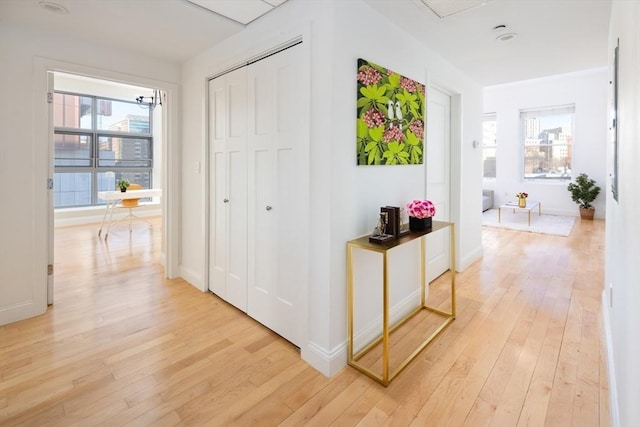 corridor with light hardwood / wood-style floors