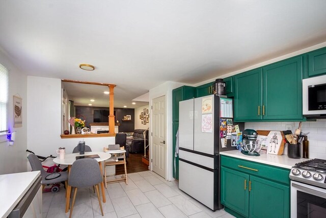 36 Pratt St, Brockton, MA 02302 - kitchen featuring freestanding refrigerator, white microwave, stainless steel gas stove, light countertops, and tasteful backsplash