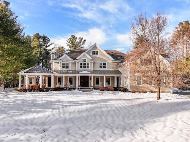 view of front of home featuring a standing seam roof, metal roof, and covered porch