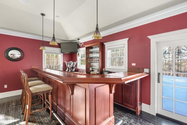 bar with crown molding, bar, vaulted ceiling, and baseboards