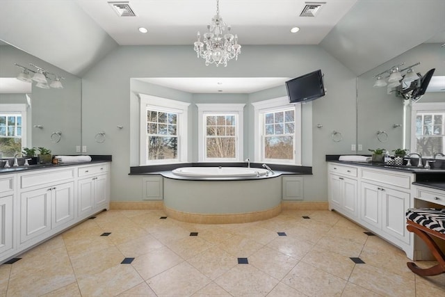 bathroom featuring lofted ceiling, visible vents, and a sink