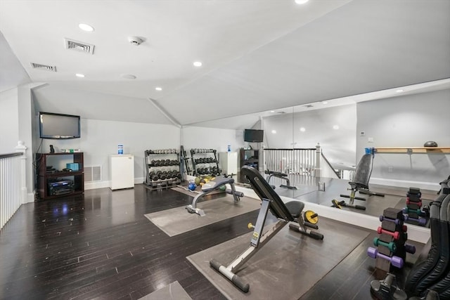 workout room featuring lofted ceiling, visible vents, wood finished floors, and recessed lighting