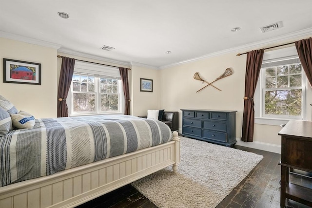 bedroom featuring dark wood-style floors, baseboards, visible vents, and ornamental molding