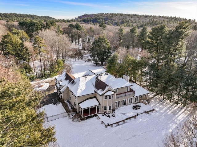 snowy aerial view with a forest view