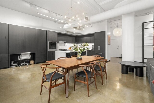 437 D St Unit 4F, Boston, MA 02210 - dining room with concrete floors, a high ceiling, and a chandelier