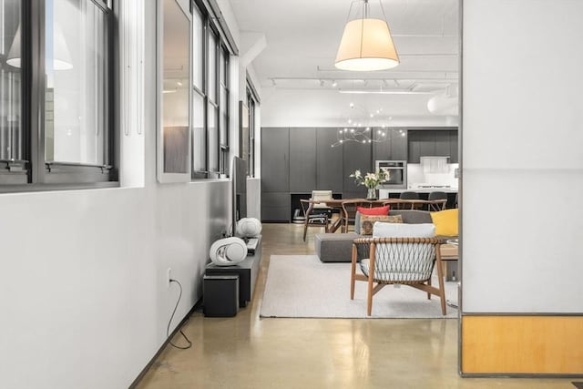 437 D St Unit 4F, Boston, MA 02210 - hall with finished concrete floors and a chandelier