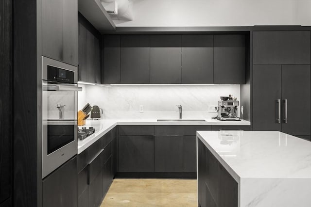 437 D St Unit 4F, Boston, MA 02210 - kitchen featuring a sink, modern cabinets, stainless steel gas stovetop, and a center island