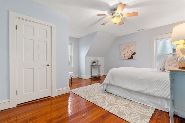 bedroom featuring wood-type flooring, lofted ceiling, and ceiling fan