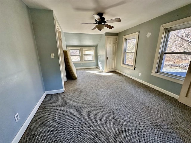 spare room featuring ceiling fan, carpet, and vaulted ceiling