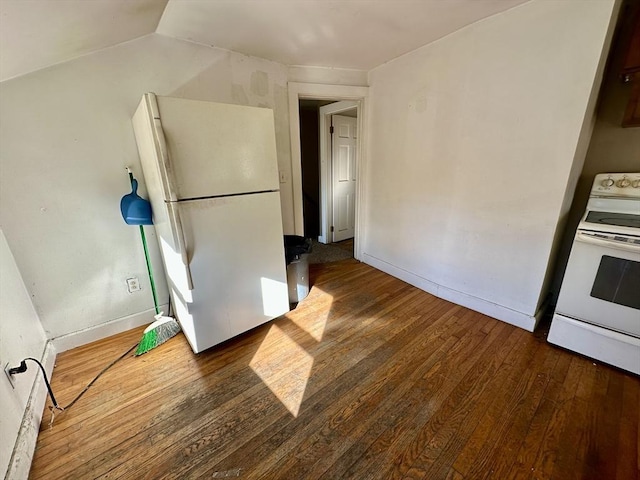 kitchen featuring white appliances, dark hardwood / wood-style floors, and lofted ceiling