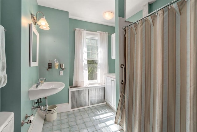 18 Milton Rd, Brookline, MA 02445 - full bath featuring radiator heating unit and a shower with shower curtain