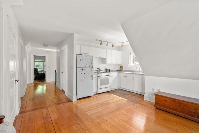 18 Milton Rd, Brookline, MA 02445 - kitchen featuring white appliances, white cabinets, light countertops, light wood-type flooring, and baseboards