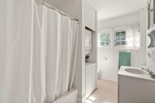 18 Milton Rd, Brookline, MA 02445 - full bath with stacked washing machine and dryer, vanity, toilet, shower / bath combo with shower curtain, and baseboards